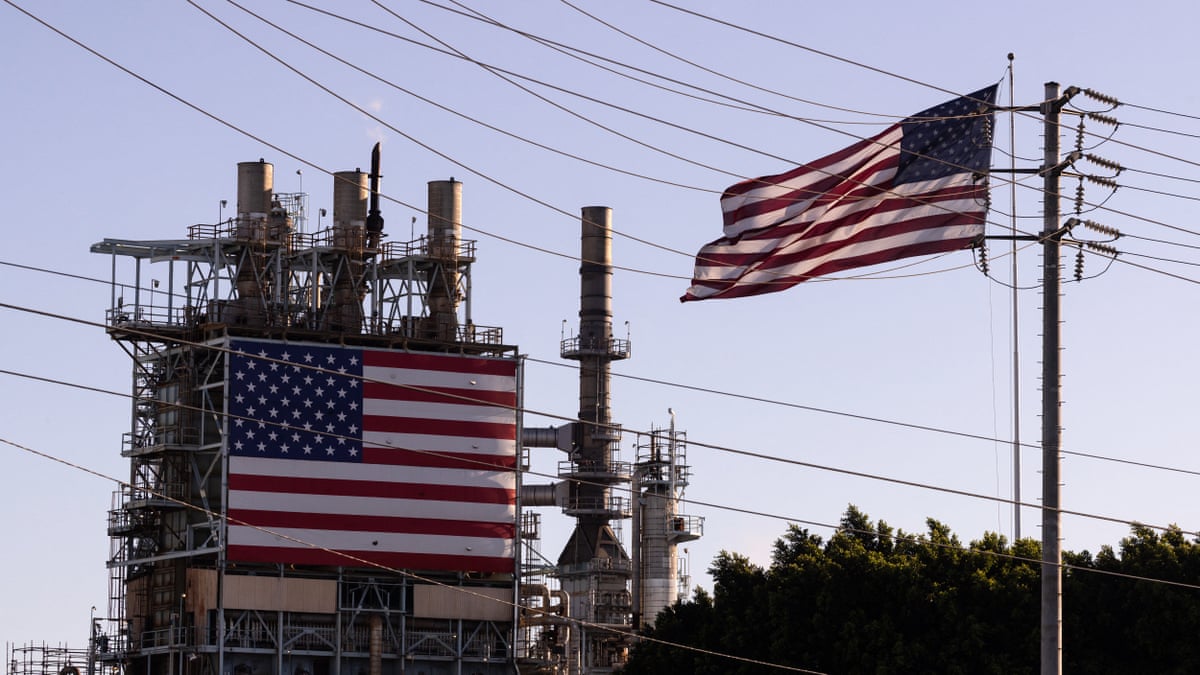 The ConocoPhillips refinery with two US flags in foreground