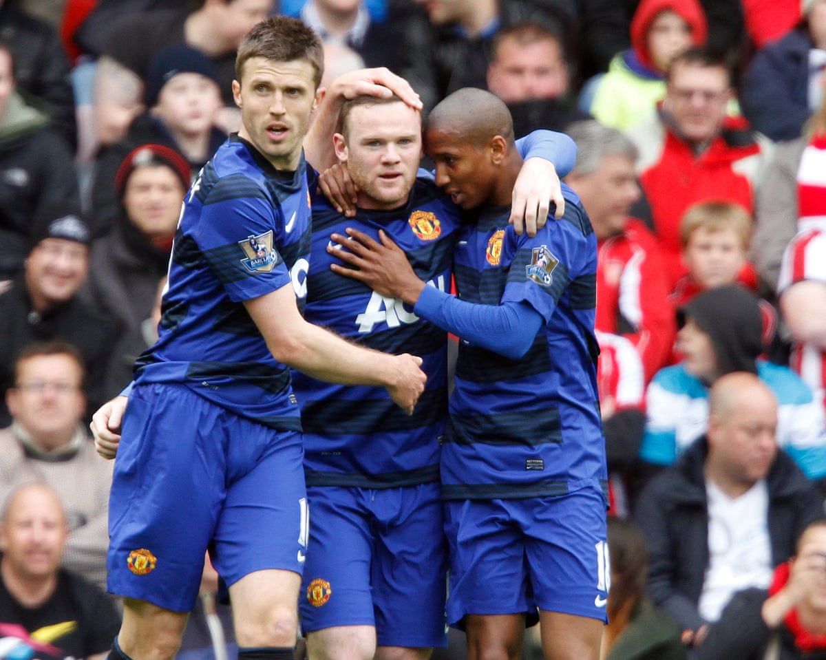 Michael Carrick, Wayne Rooney and Ashley Young celebrate a Manchester United goal in 2012