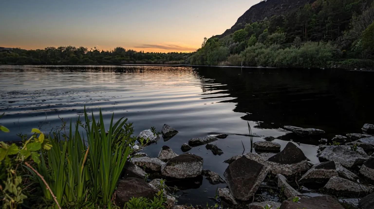 Steph Virot A sunset over a loch, with the water clearly rippling.