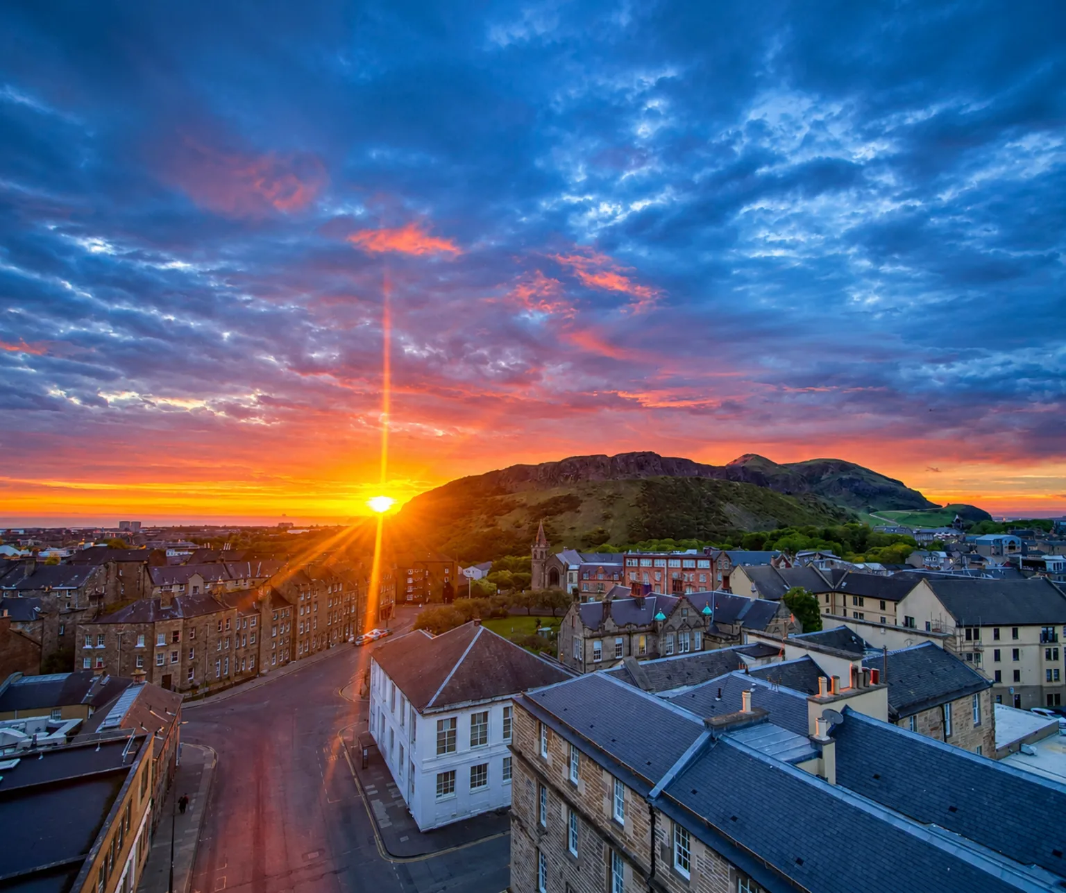 Derek McEwan A sunrise over Edinburgh, with hills and homes visible