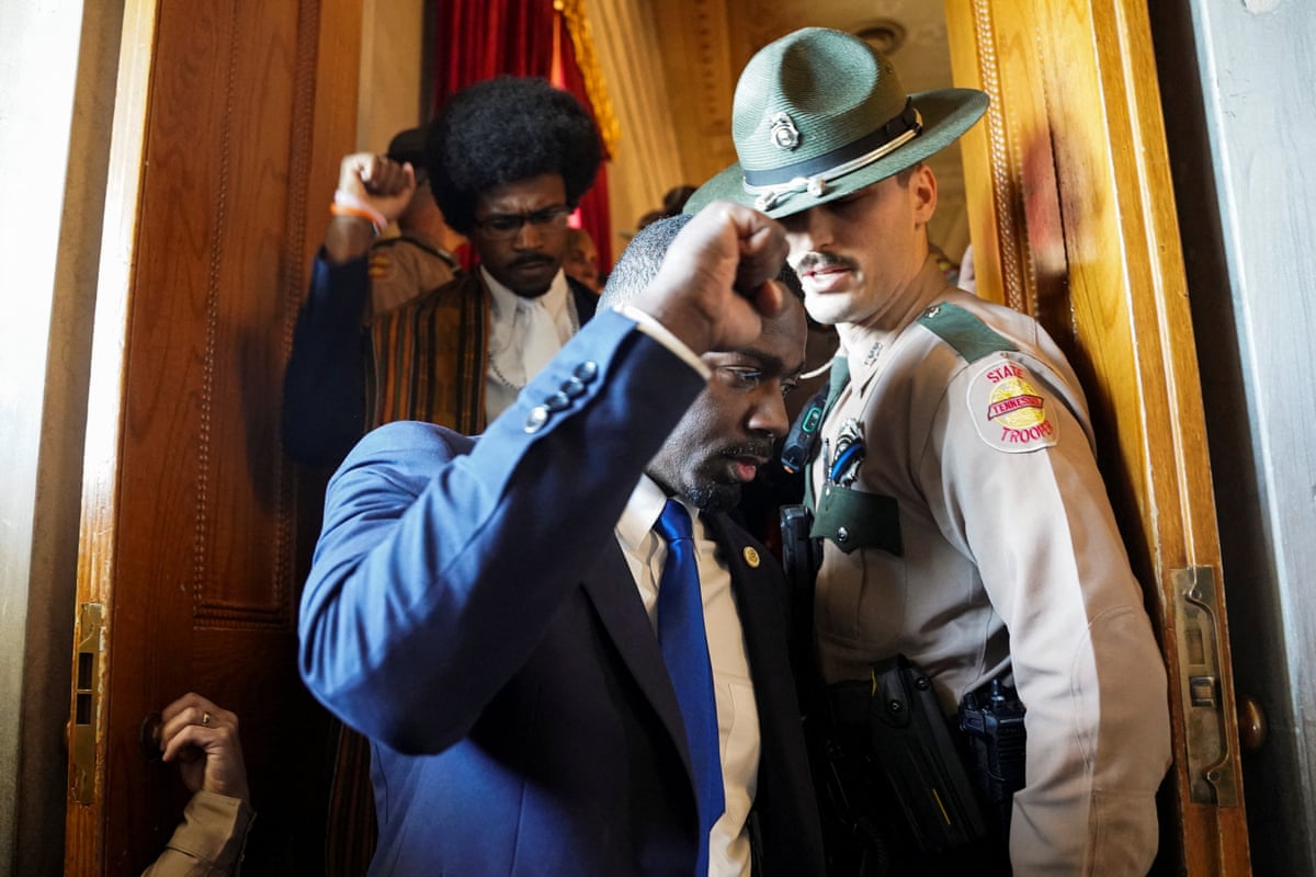 Democratic state representative Justin J. Pearson and his brother KeShaun Pearson hold their fists up as they are removed from the House gallery after taking part in a silent sit-in protesting the Republican redistricting efforts.