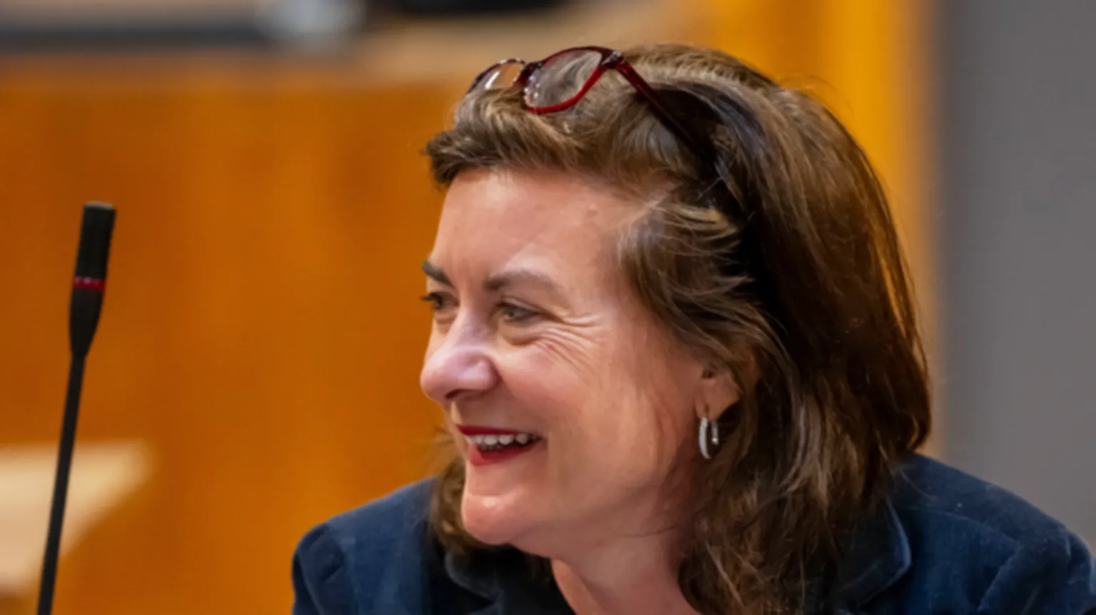 Senedd Cymru Eluned Morgan smiling in the Senedd debating chamber