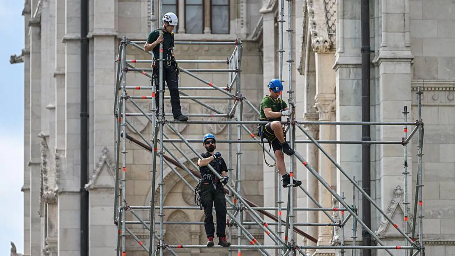 AFP via Workers build metal scaffolding at the Hungarian Parliament building as preparations are underway on May 7, 2026 in Budapest's Kossuth Square for the inaugural session of the new parliament