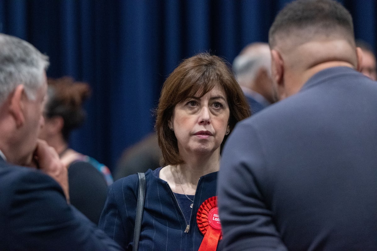 Labour’s deputy leader, Lucy Powell, in Manchester wearing a red rosette surrounded by other people