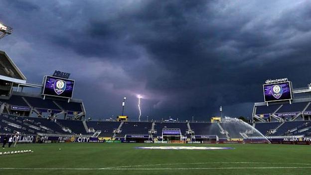 Lightning strikes near the Orlando Citrus Bowl as a severe weather warning forces the evacuation of the stands before the start of the Orlando City against FC Dallas game, in Orlando, Fla., on Saturday, July 11, 2015