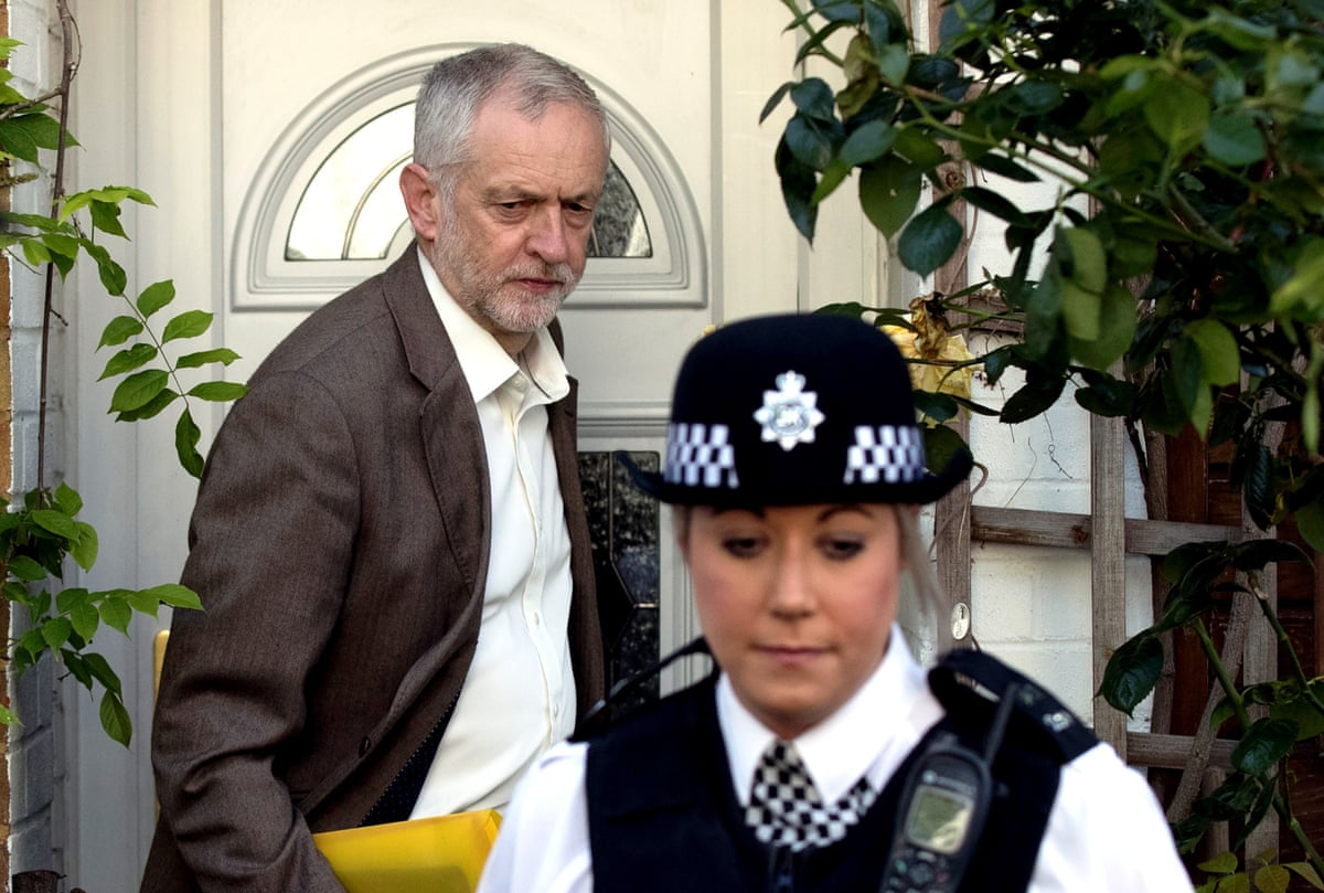 Jeremy Corbyn leaves his house with a police officer escort