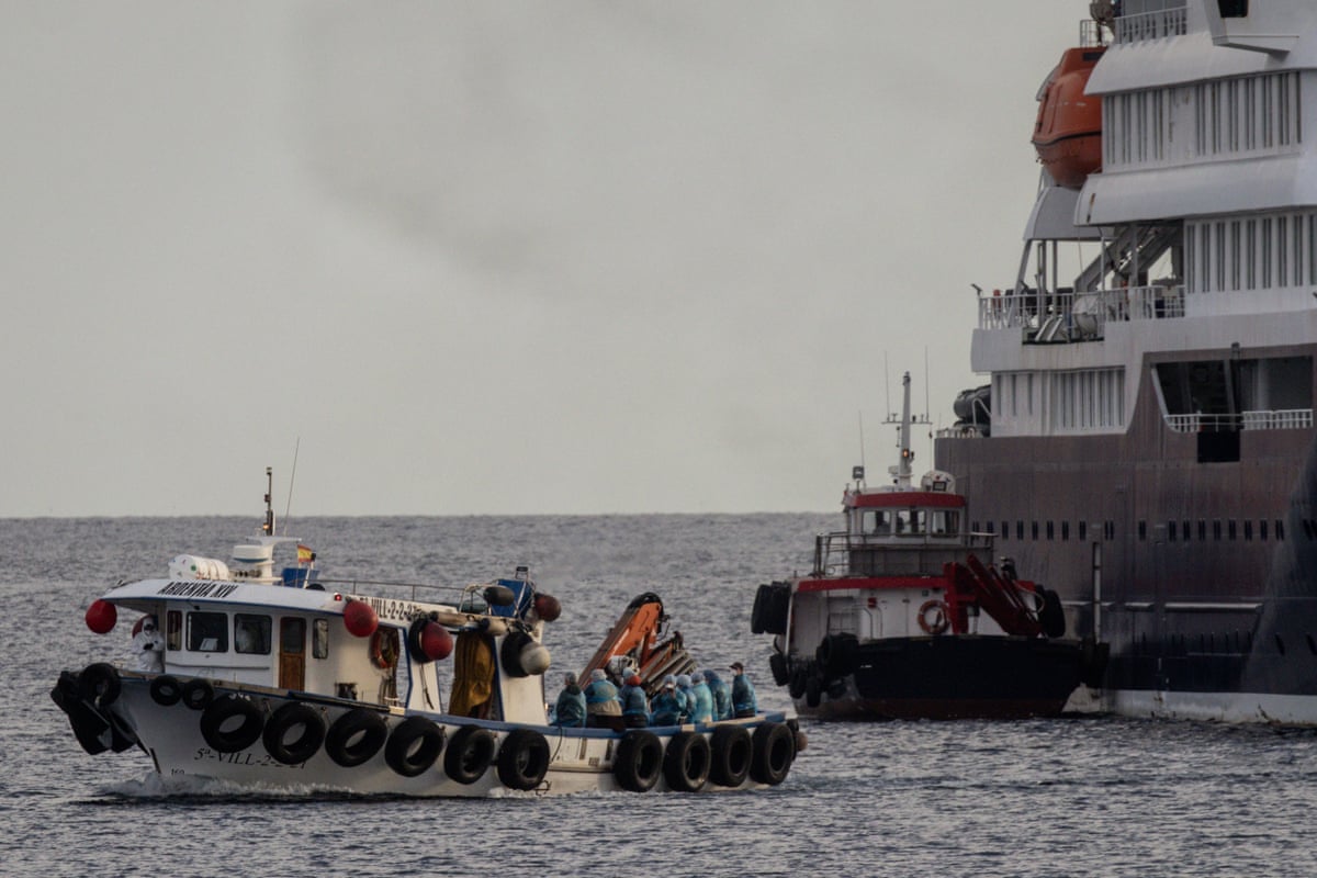 American citizens (dressed in blue) are evacuated in a small boat from the MV Hondius on 10 May in Tenerife