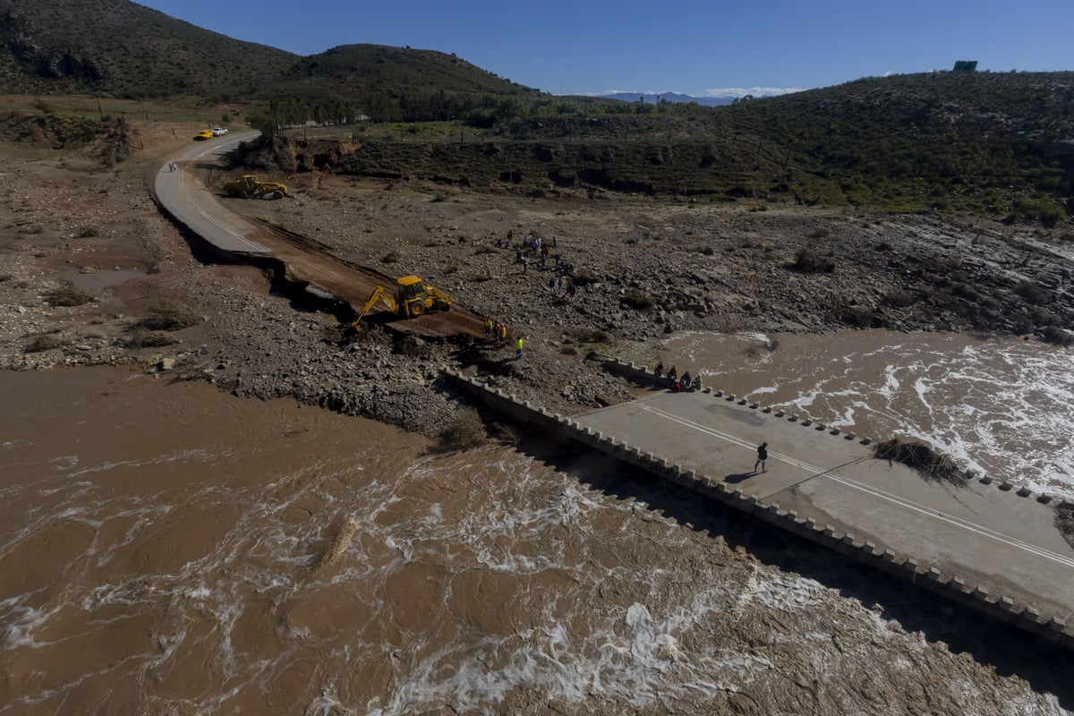 Workers repair a bridge damaged by flooding in Western Cape, South Africa.