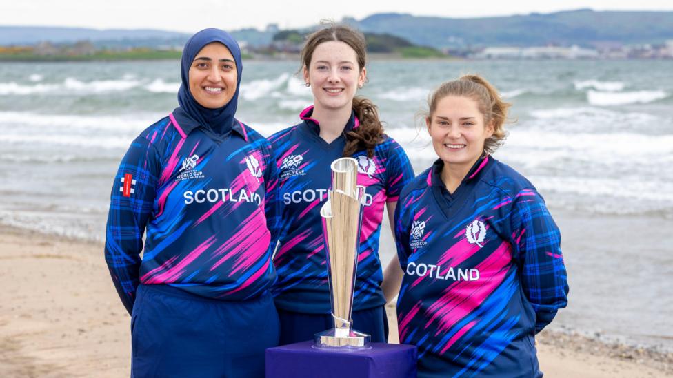 Scotland players Abtaha Maqsood, Gabriella Fontenla and Megan McCall pose with the World Cup trophy at Prestwick beach