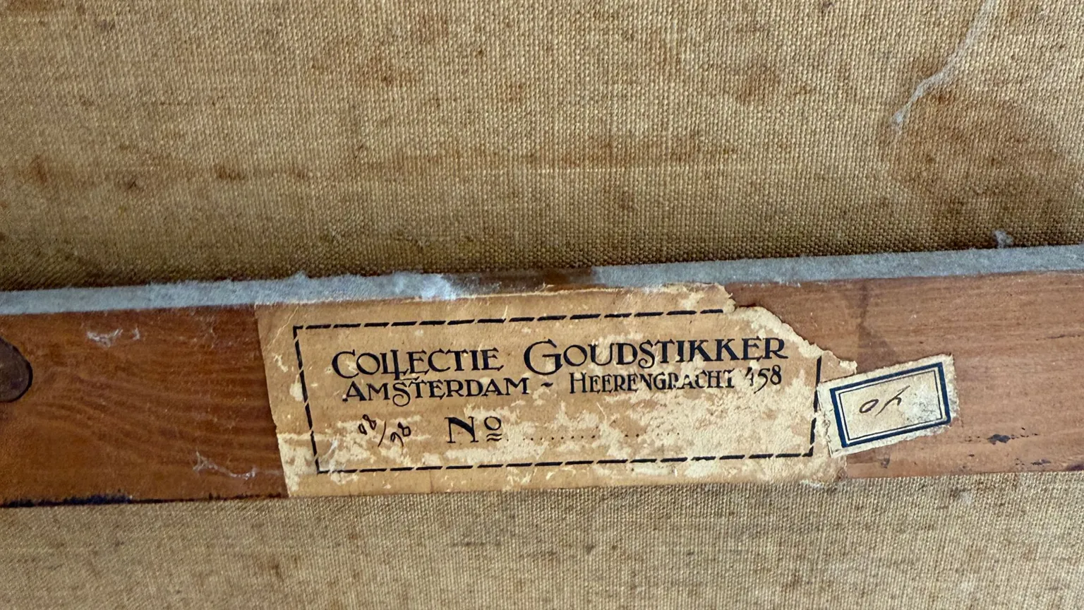 Arthur Brand A worn brown sticker on the back of the Portrait of a Young Girl's frame, it reads 'Collectie Goudstikker' and is partially torn at its edges.
