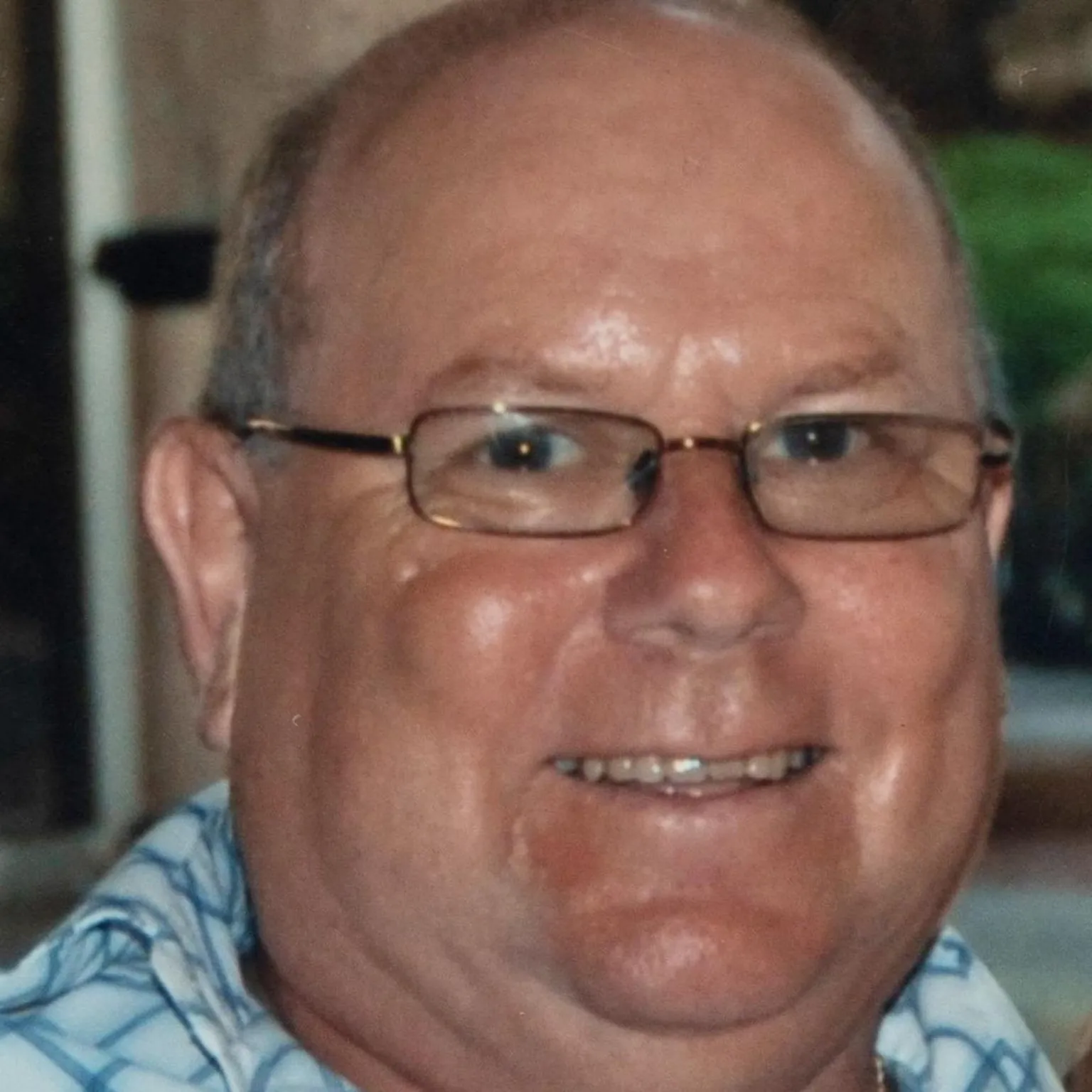 SWNS David Pethig who has grey hair and is wearing rectangular glasses and a shirt