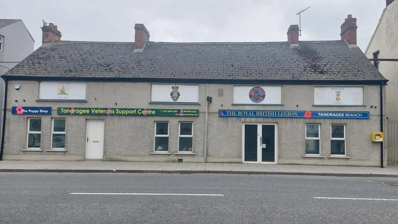 The Royal British Legion building in Tandragee and the Tandragee Veterans Support Centre.. Two grey buildings next to each other, you can also see the logo of both buildings
