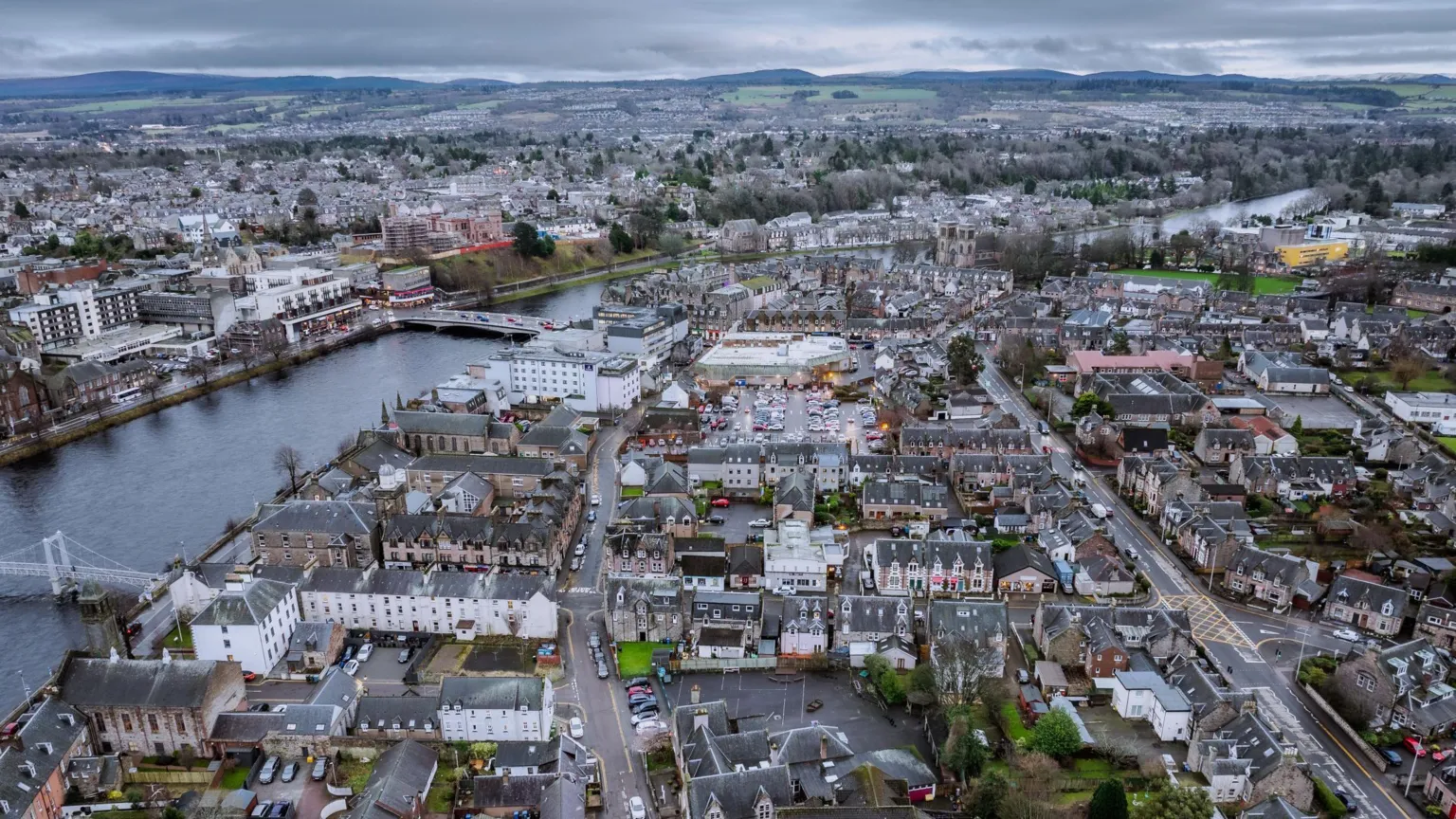  A view across Inverness, the River Ness and rows of houses and other buildings either side of the river.