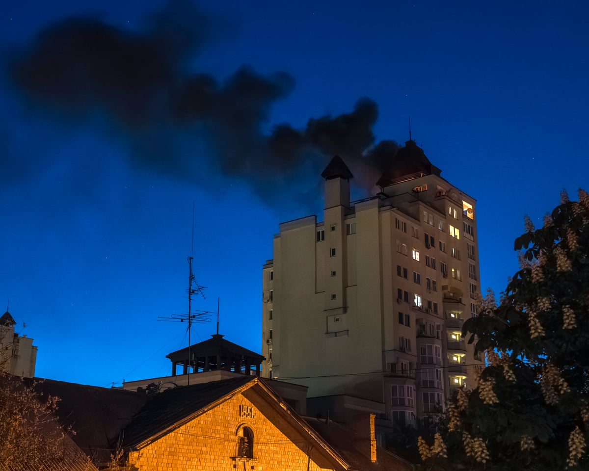 Smoke billows after debris from an intercepted Russian drone fell on the roof of a high-rise residential building in Kyiv, Ukraine.