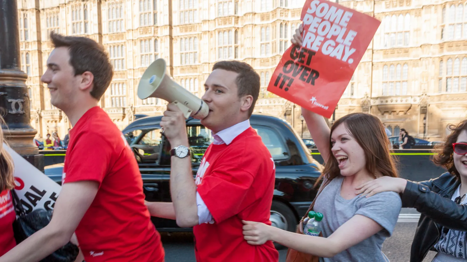 Wes Streeting pictured doing a conga with activists from Stonewall outside Parliament in 2013