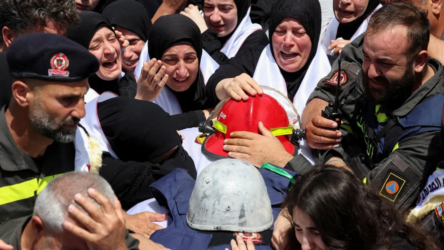  Mourners attend the funeral of Lebanese Civil Defence paramedics Hussein Jaber and Ahmed Noura, who were killed in an Israeli air strike, in Sidon, southern Lebanon (13 May 2026)
