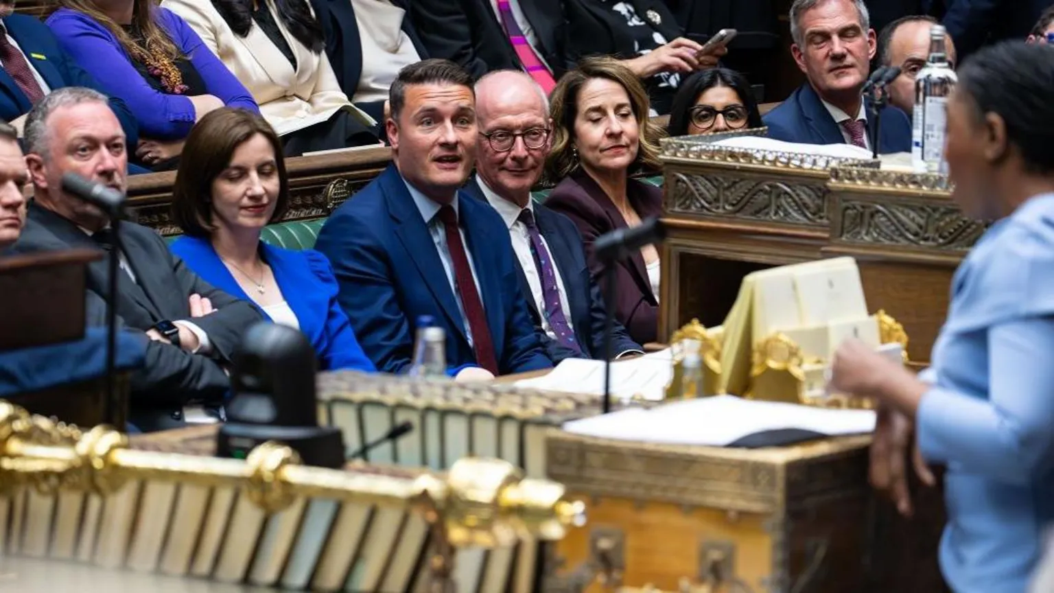  Handout photo issued by the House of Commons of the Leader of the Opposition, Kemi Badenoch, watched by Health Secretary Wes Streeting and others on the Government Front Bench, during the debate on the King's Speech in the House of Commons, London, following the State Opening of Parliament.