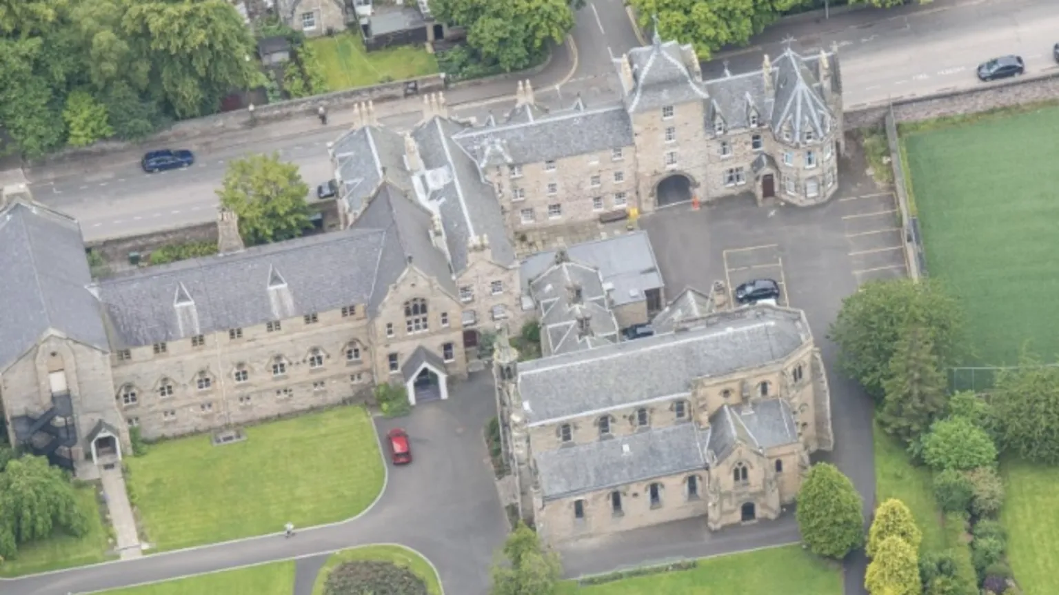 Historic Environment Scotland A set of historic buildings surrounded by grass and trees from above