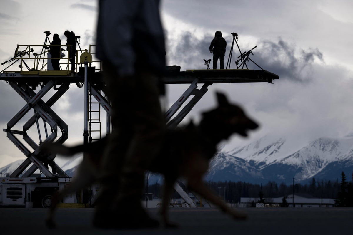 Counter snipers and other security forces watch over Air Force One while refuelling at Joint Base Elmendorf