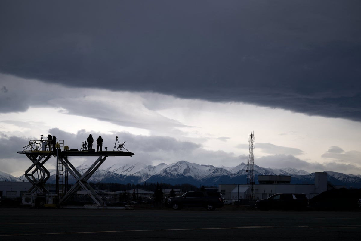 Security forces watch over Air Force One while refuelling at Joint Base Elmendorf in Alaska.