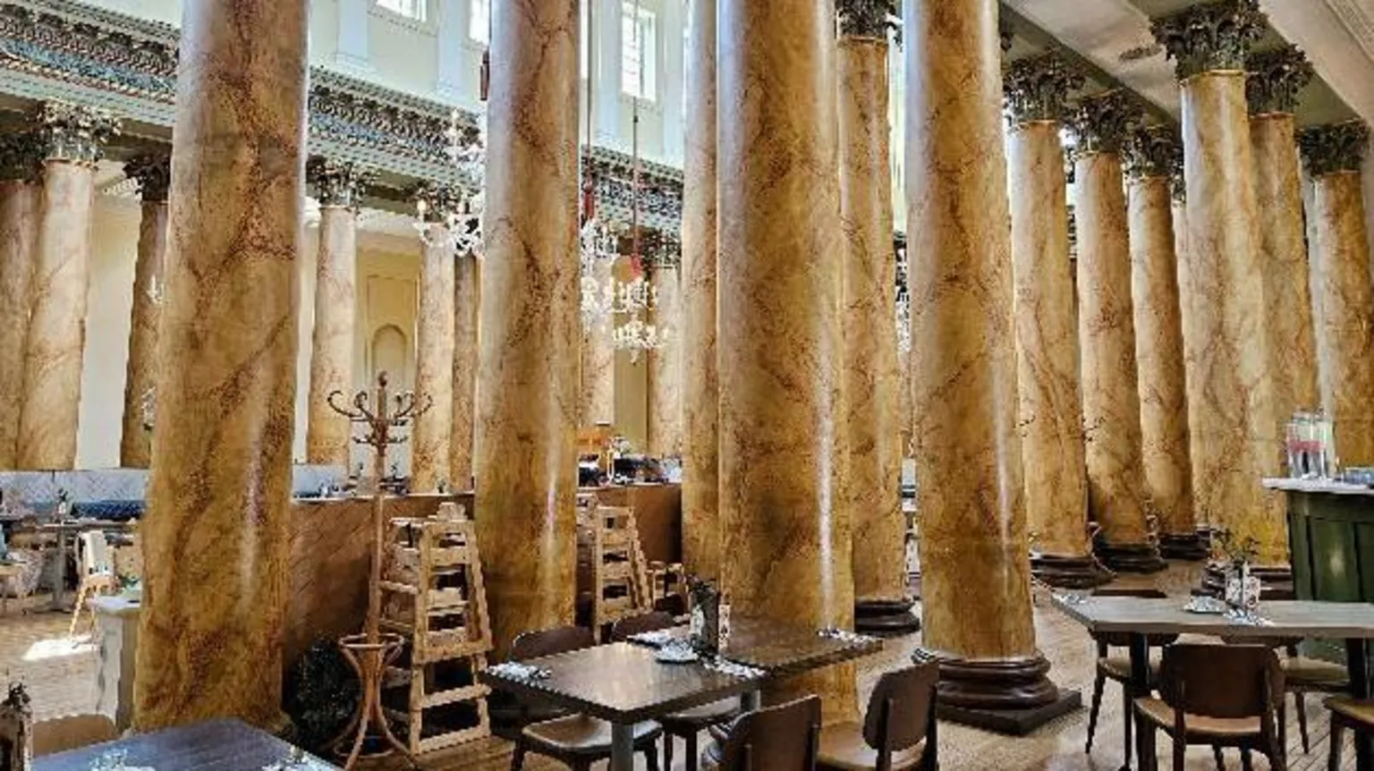 Sue Gabbatiss The inside of York's Assembly Rooms. Tables and chairs on a tiled floor next to numerous marble pillars, a high ceiling and ornate architectural detailing. Several crystal chandeliers hang down between the columns.