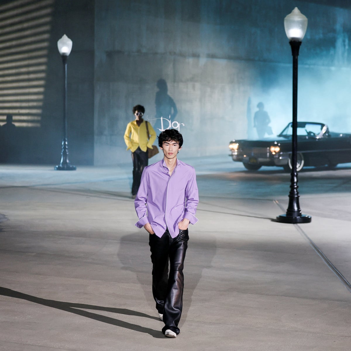 Two models with streetlight and Cadillac behind