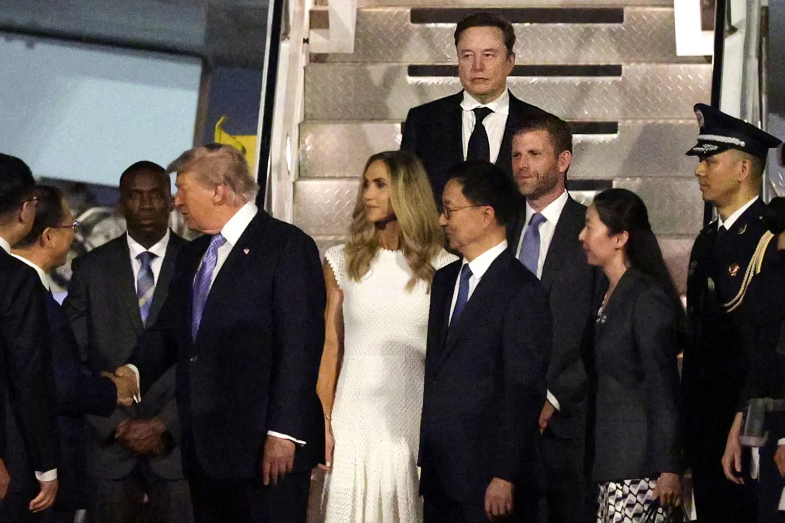 SpaceX CEO Elon Musk, Eric Trump and Lara Trump depart Air Force One as U.S. President Donald Trump greets a local official upon arrival at Beijing Capital International Airport on May 13, 2026 in Beijing, China.