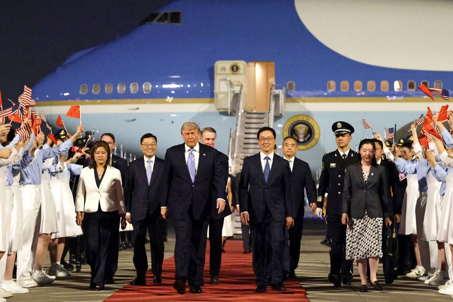 U.S. President Donald Trump (C) is joined by Chinese Executive Vice Minister of Foreign Affairs Ma Zhaoxu, U.S. Ambassador to China David Perdue, Vice President of China Han Zheng and Chinese Ambassador to the U.S. Xie Feng as he arrives at Beijing Capital International Airport on May 13, 2026 in Beijing, China.