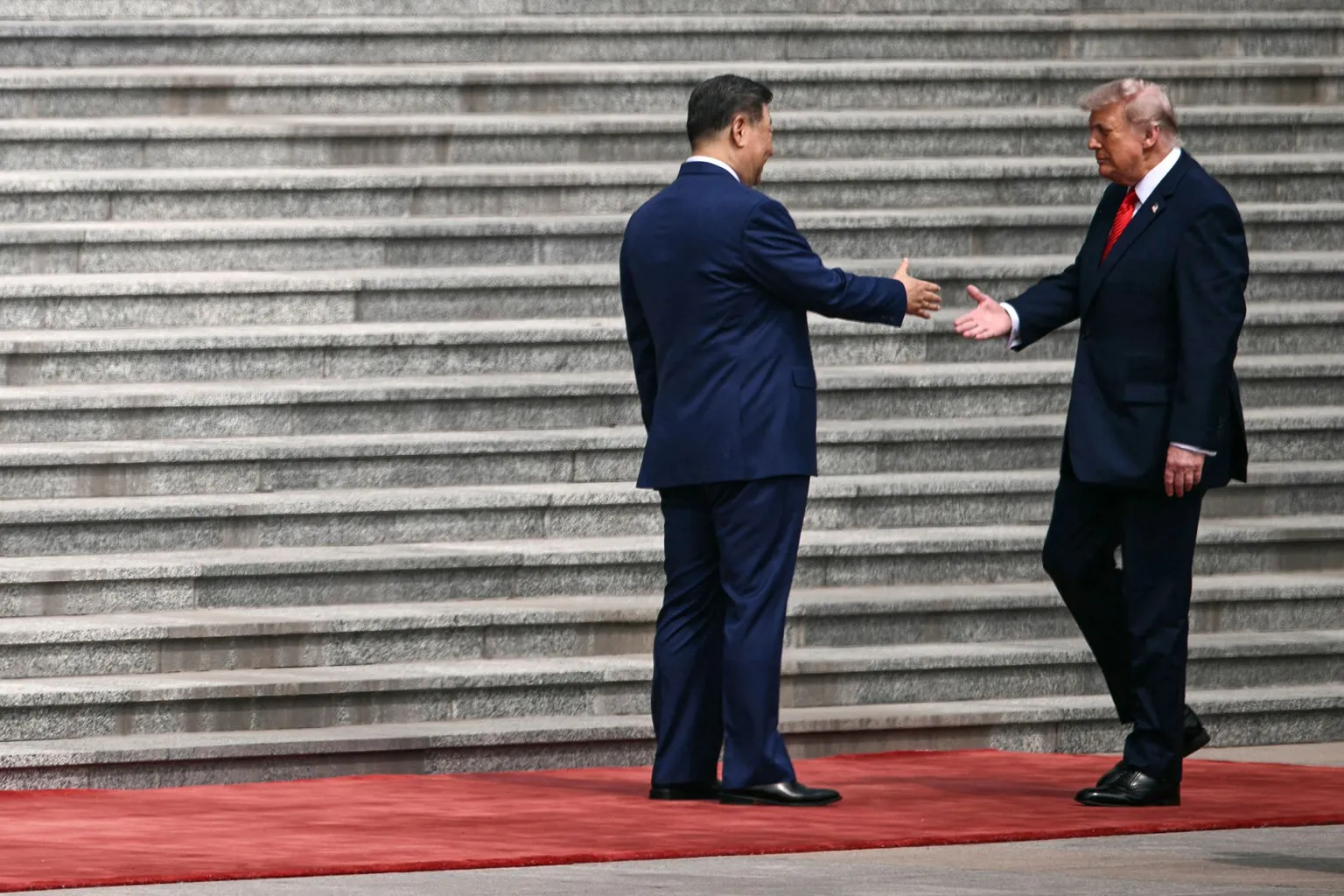 AFP via US President Donald Trump (R) shakes hands with China's President Xi Jinping during a welcome ceremony at the Great Hall of the People in Beijing on May 14, 2026.