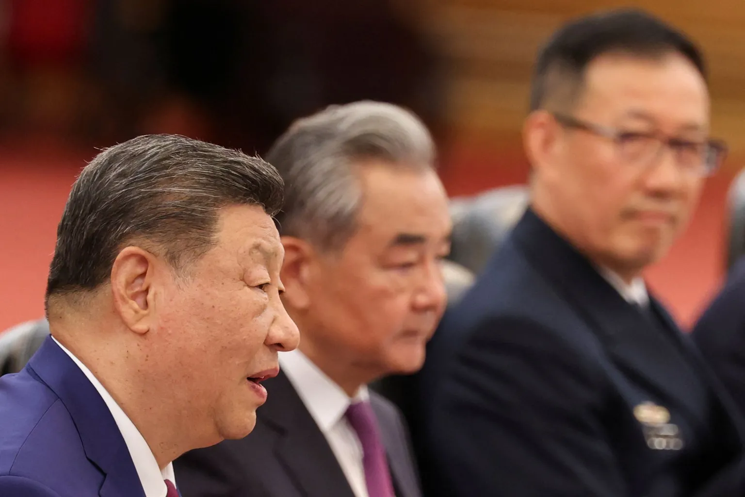 Chinese President Xi Jinping, seated next to China’s Foreign Minister Wang Yi, attends a bilateral meeting with U.S. President Donald Trump (not pictured) at the Great Hall of the People, in Beijing, China May 14, 2026.