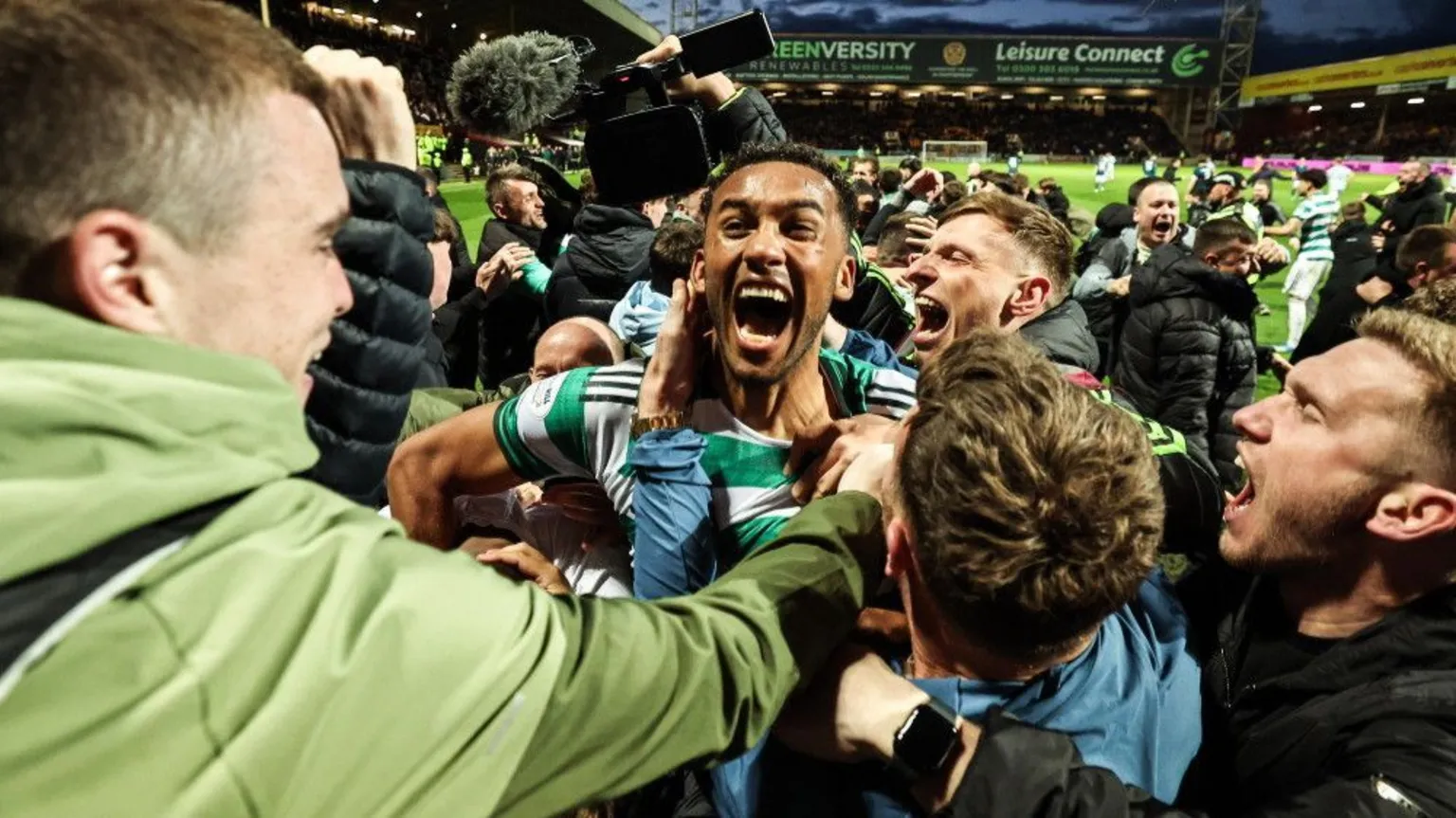  Celtic fans celebrating with players