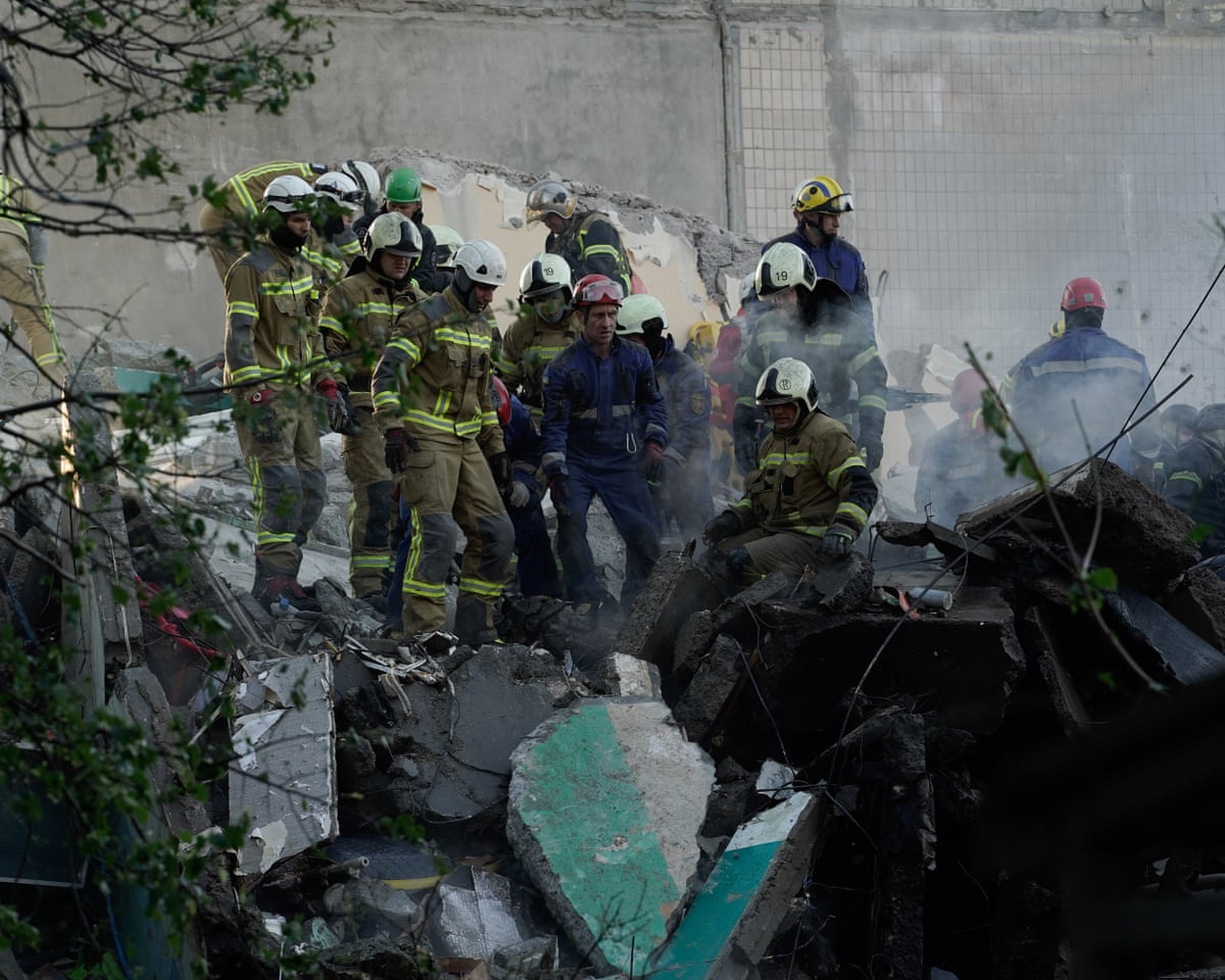 Rescue workers clear the rubble of a destroyed apartment building after a Russian drone and missile attack in Kyiv, Ukraine.