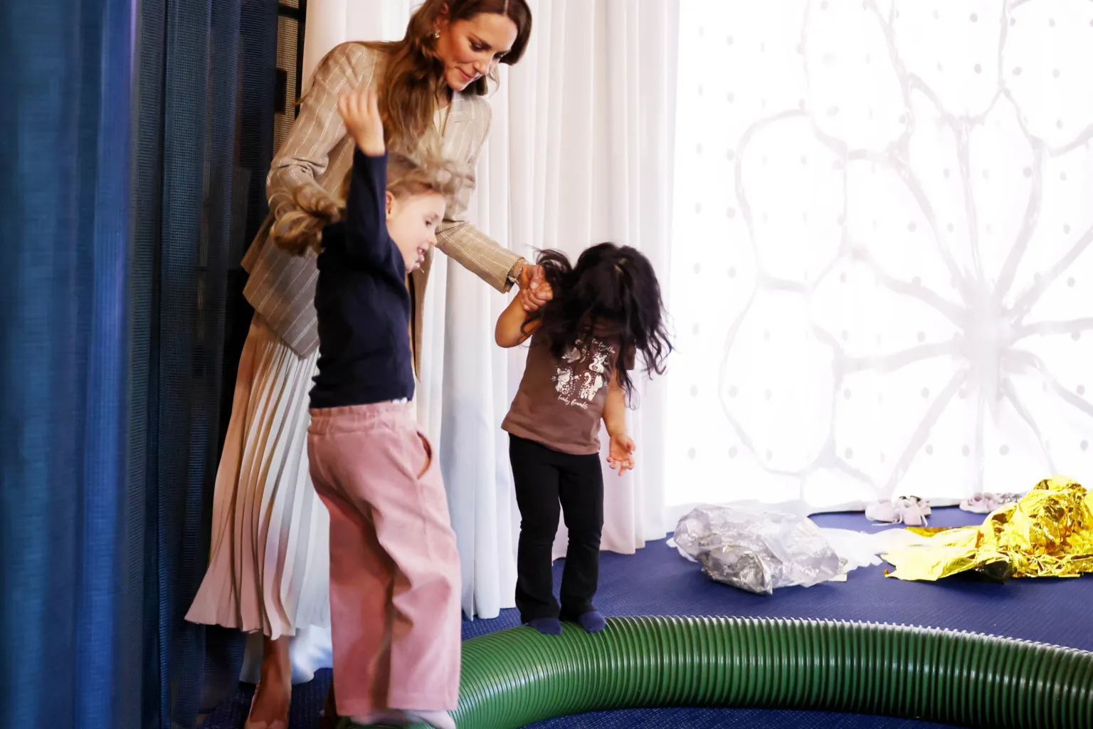 The Princess of Wales plays with children in a early years centre in Italy.