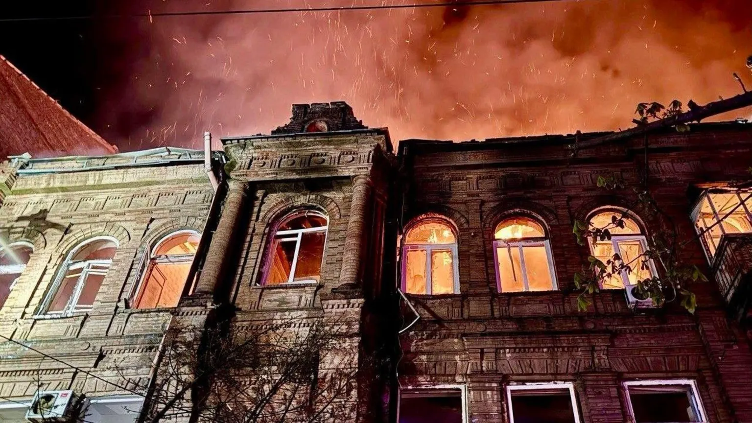 Dnipropetrovsk Regional State Administration A building damaged and on fire in Dnipro, Ukraine, in April 2026. The roof appears to have caved in and the windows are lit by fire, as is the night sky.