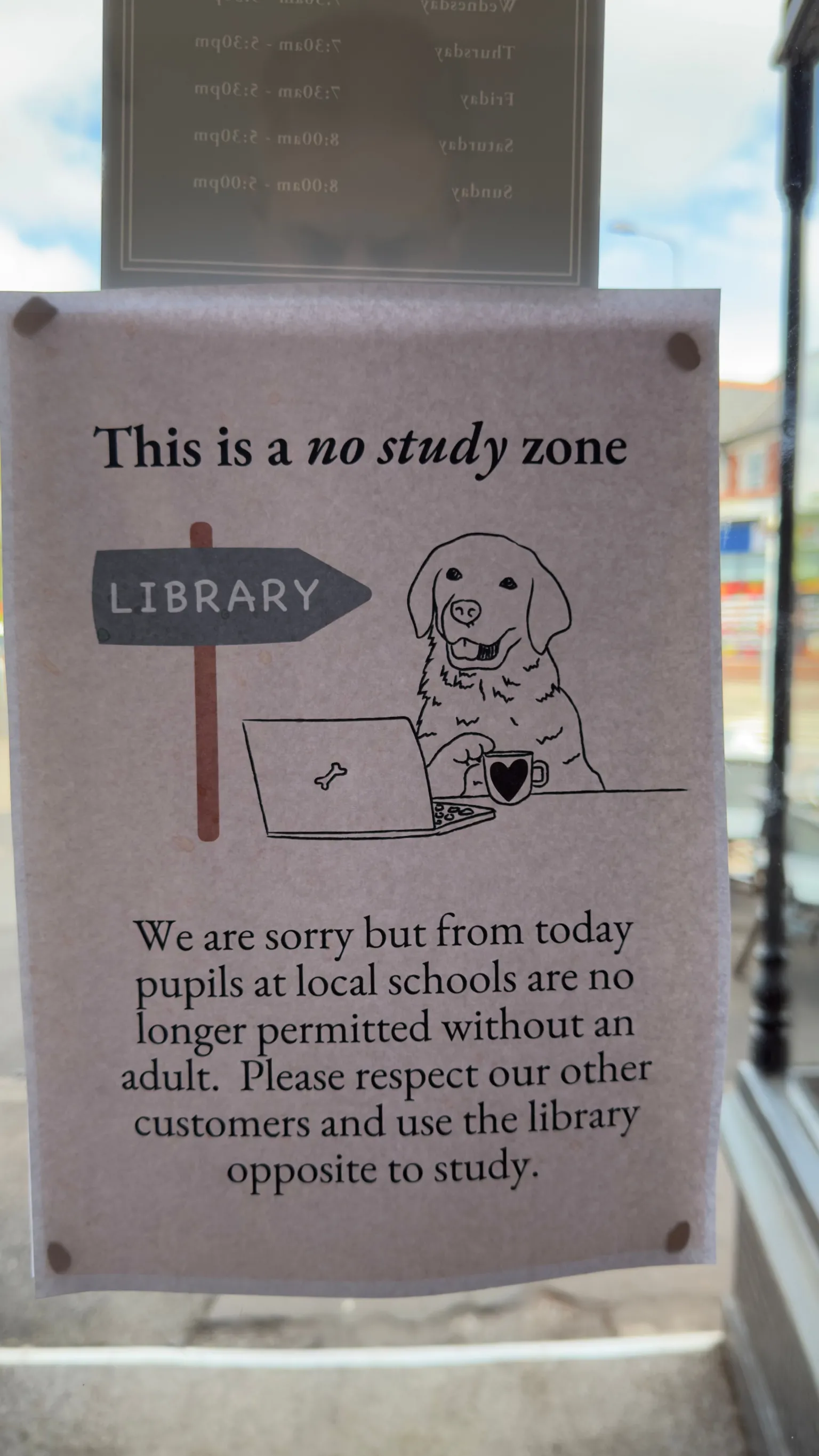 Tom Griffin A sign stuck to a window. It reads - 
