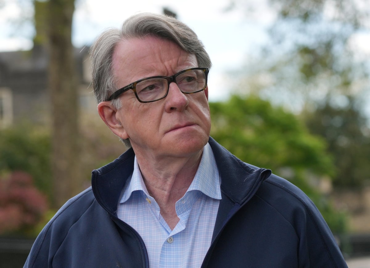 Peter Mandelson seen outside his home in London in a blue shirt and a dark blue jacket