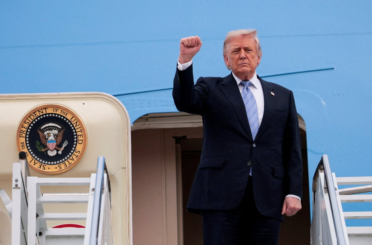 US president Donald Trump gestures as boards Air Force One.