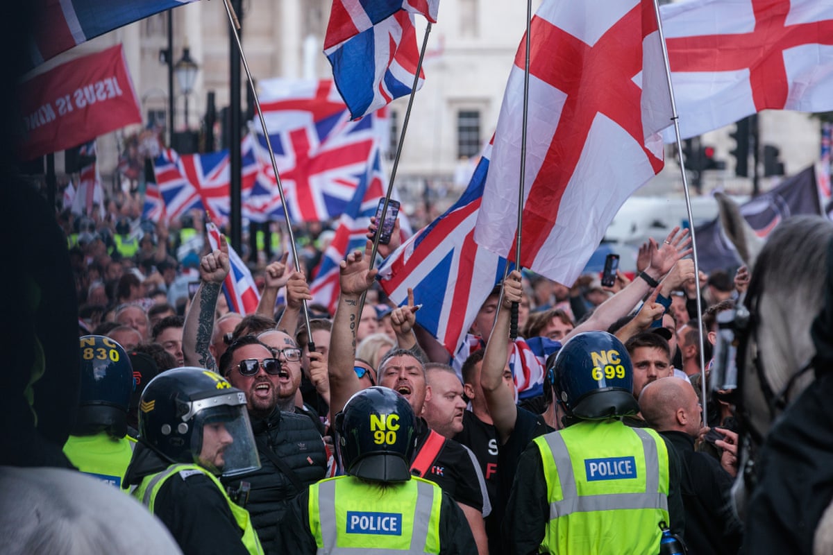 Police officers form a cordon in front of supporters of far-right activist Tommy Robinson in the 'Unite the Kingdom' demonstration in September 2025.