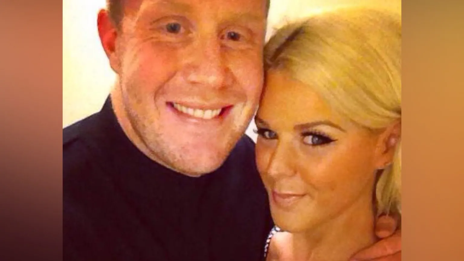 Danny Cahalane/Facebook The image looks like a close‑up selfie of two people standing very close together - Danny Cahalane on the left and Paris Wilson on the right. He is wearing a dark top, and his arm is around the her shoulder. She has light‑coloured hair pulled back and is wearing a sleeveless outfit with a beaded or sparkly trim along the strap. The lighting is warm, giving the whole scene a soft yellow tone.