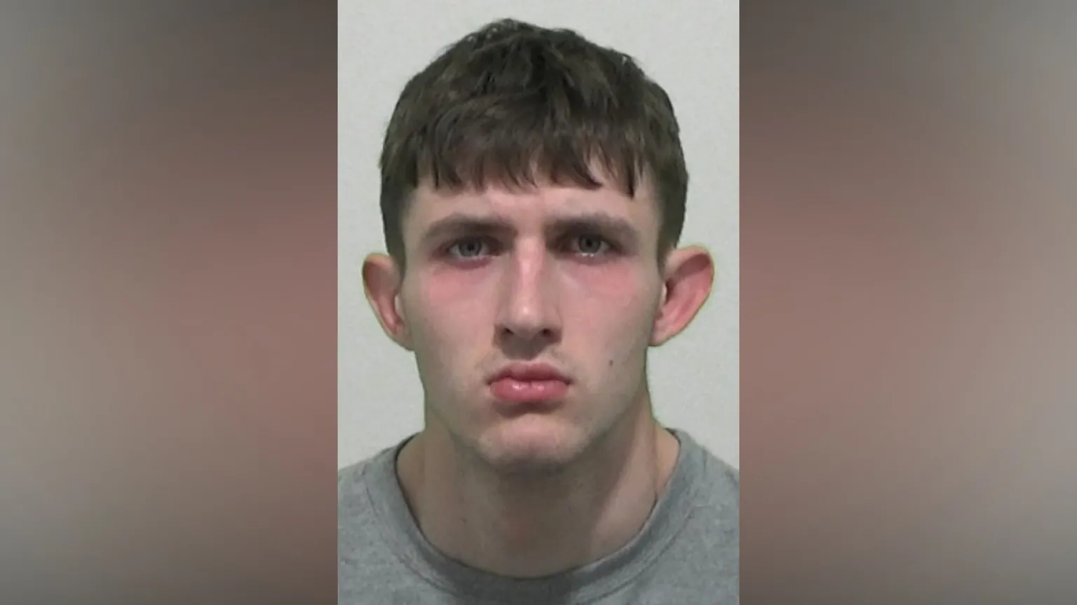 Northumbria Police Mugshot of Stokoe. He is clean shaven with short black hair.