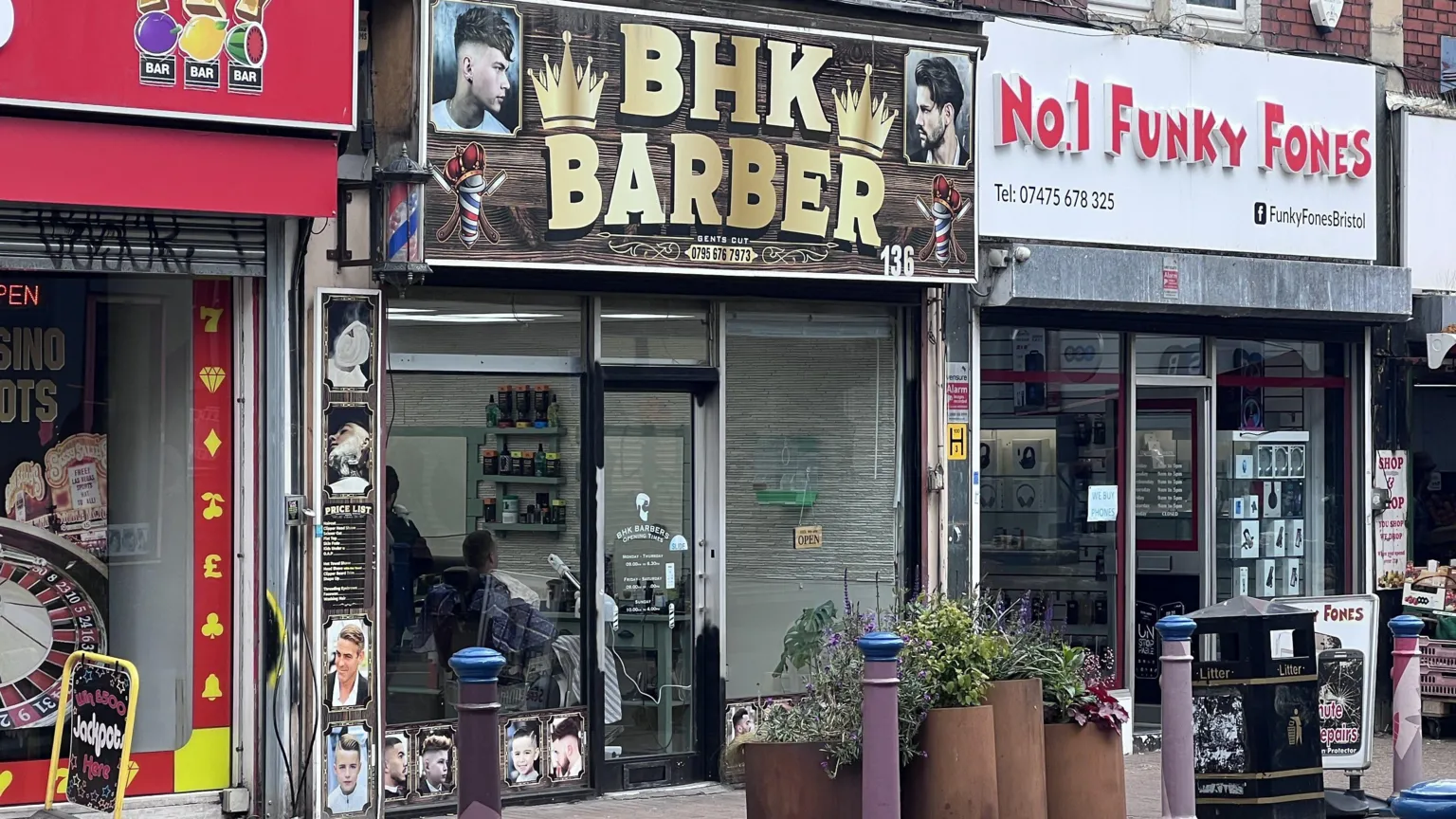 BHK Barber shop front on a highstreet. The barber shop is part of a rank of shops. 