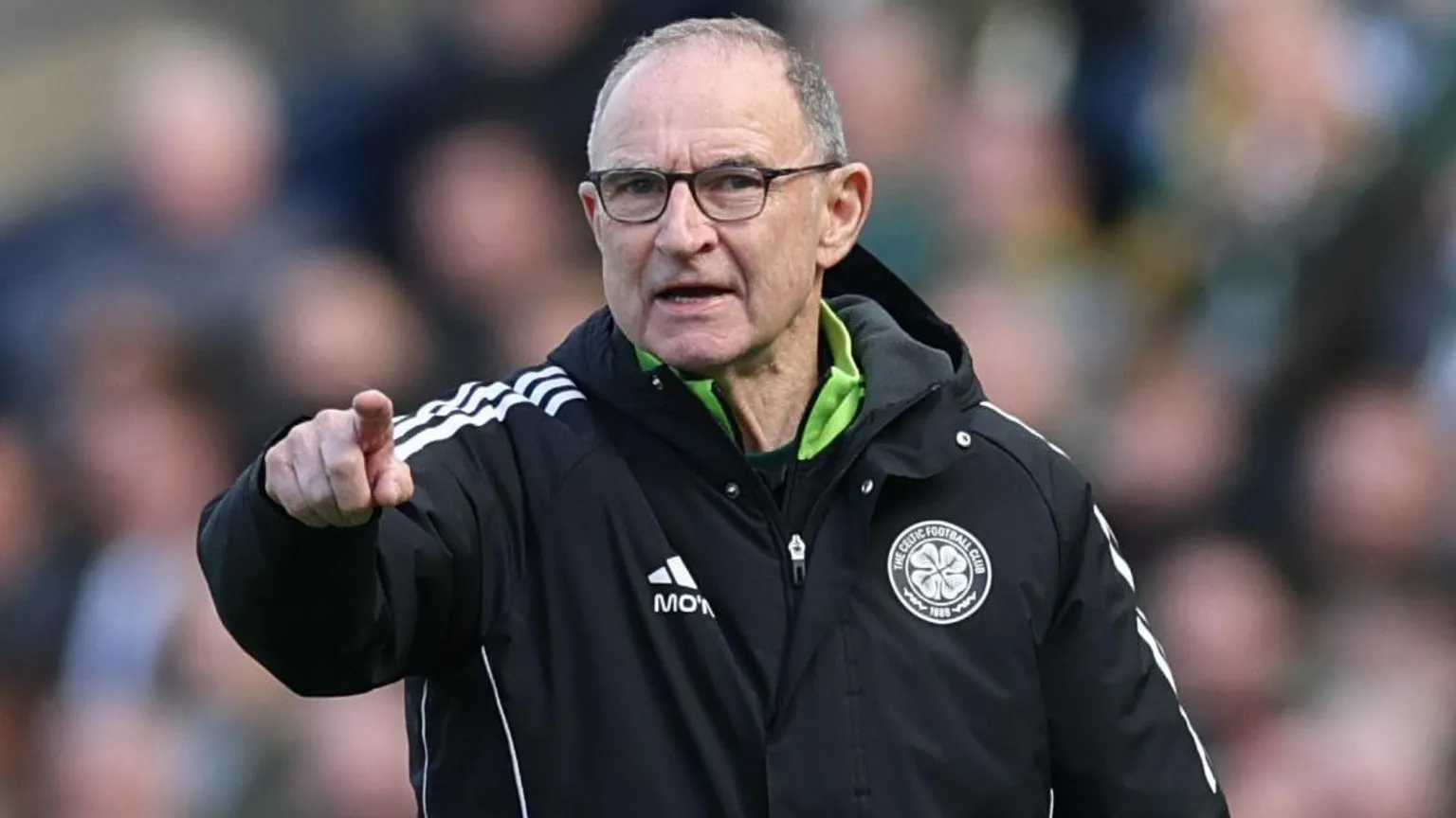  Celtic Martin O'Neill shouts instructions to his players during a match. He is wearing a black Adidas jacket with the club's crest on one side and his initials - below the Adidas logo - on the other.