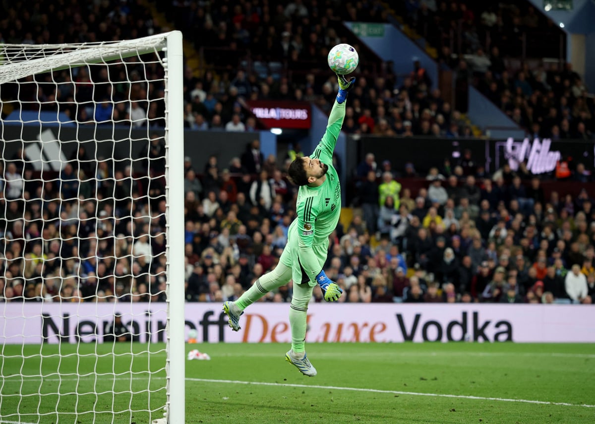 Aston Villa’s John McGinn scores their fourth goal past Liverpool’s Giorgi Mamardashvili.