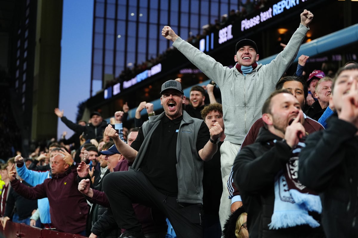 Aston Villa fans celebrate after Ollie Watkins scores their side's second goal.