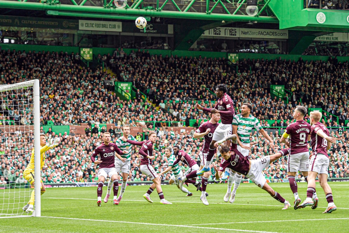 Auston Trusty of Celtic (third right) beats Hearts’ Landry Kabore in the air but heads the ball over the bar.