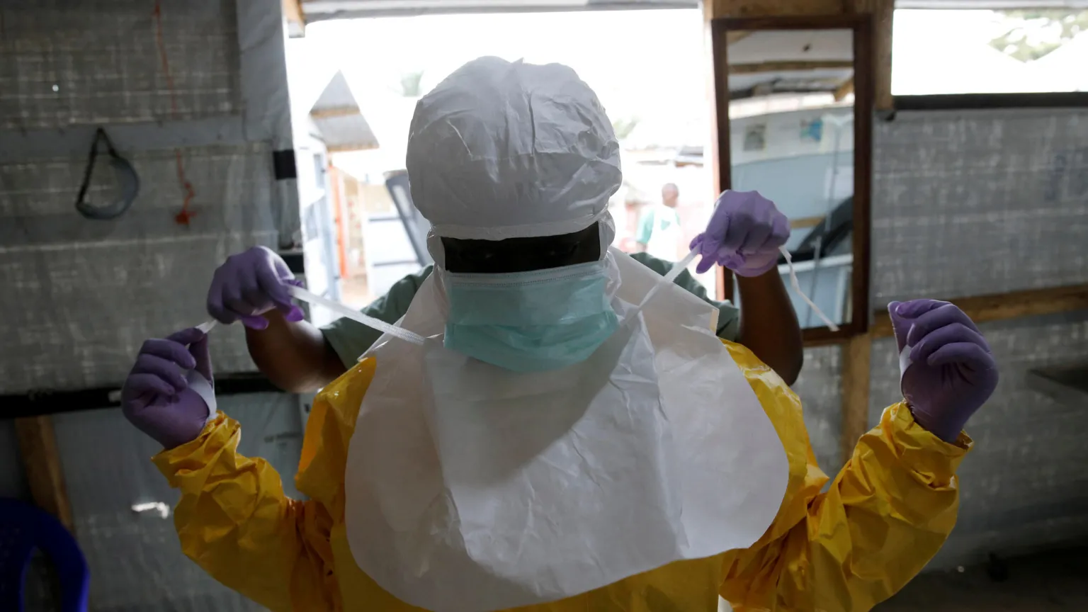  A health worker puts on Ebola protection gear before entering the Biosecure Emergency Care Unit (CUBE) at an Ebola treatment centre in Beni, in the Democratic Republic of Congo. 