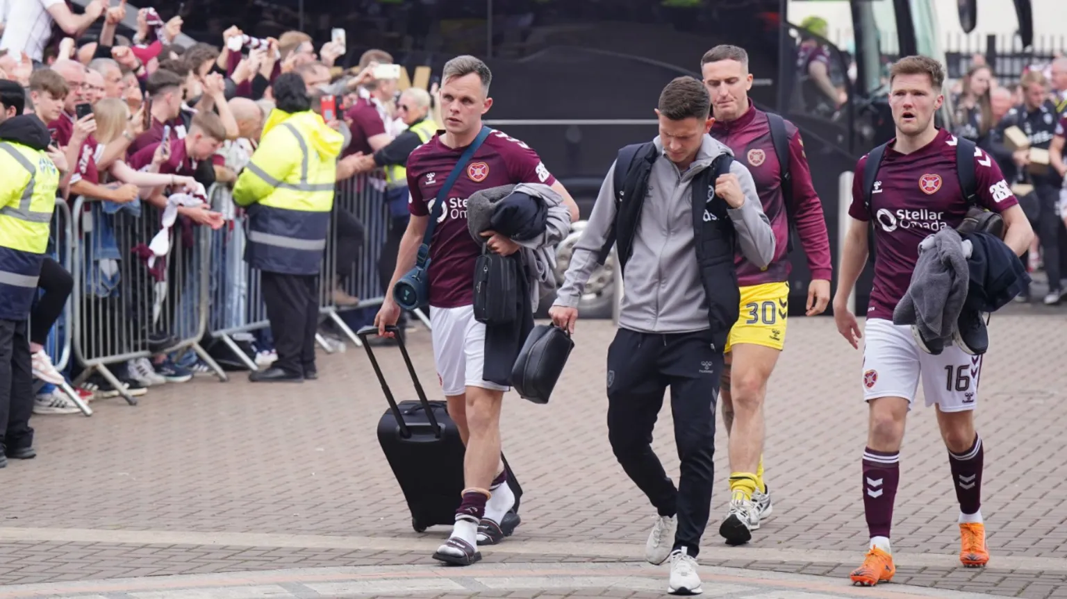  Defeated Hearts players were met by crowds of fans as they returned to Tynecastle. Three of the players are still wearing their maroon and white match kits.