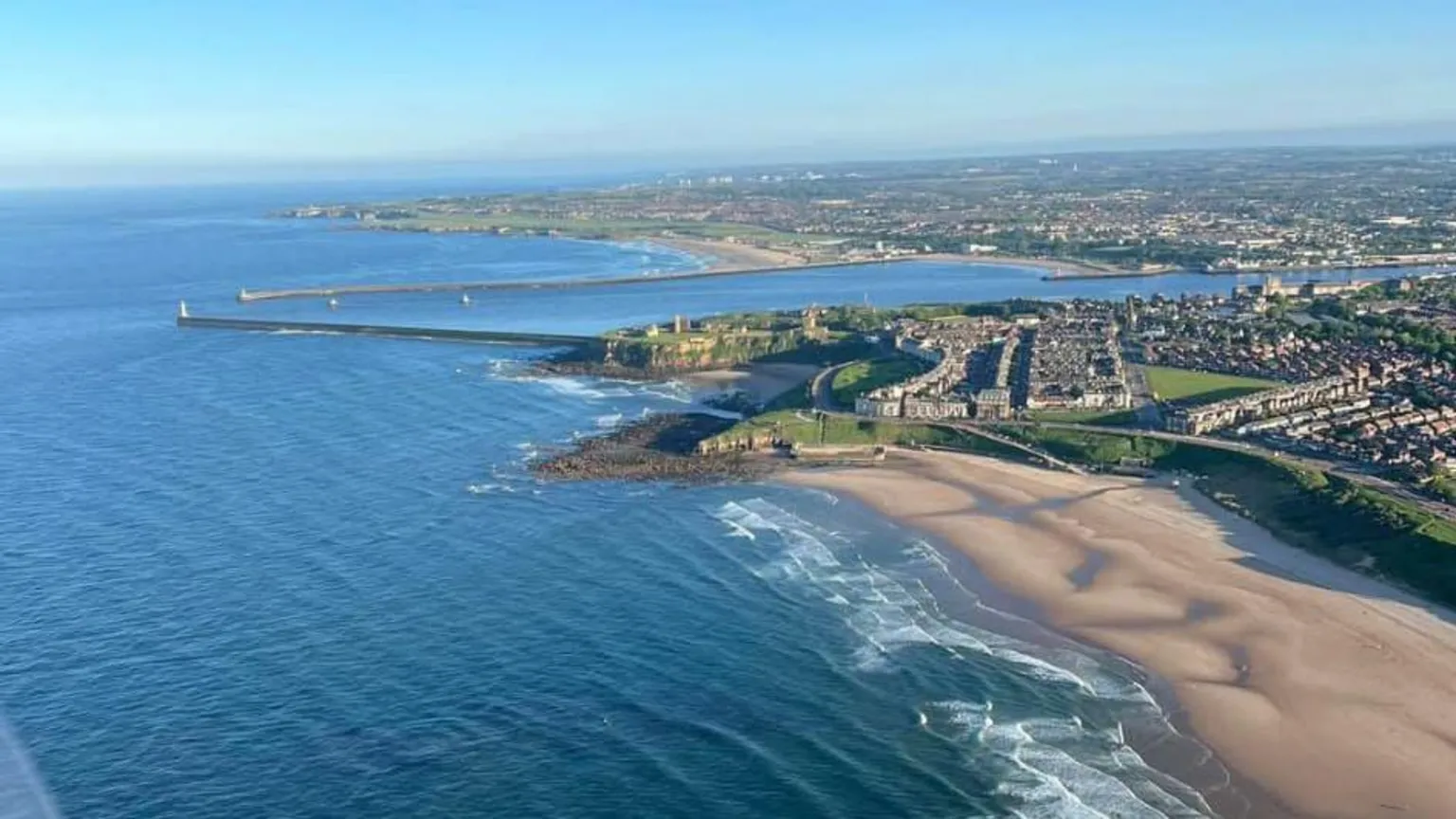 Geoff Cowan An aerial view of Longsands beach with houses on the clifftop.