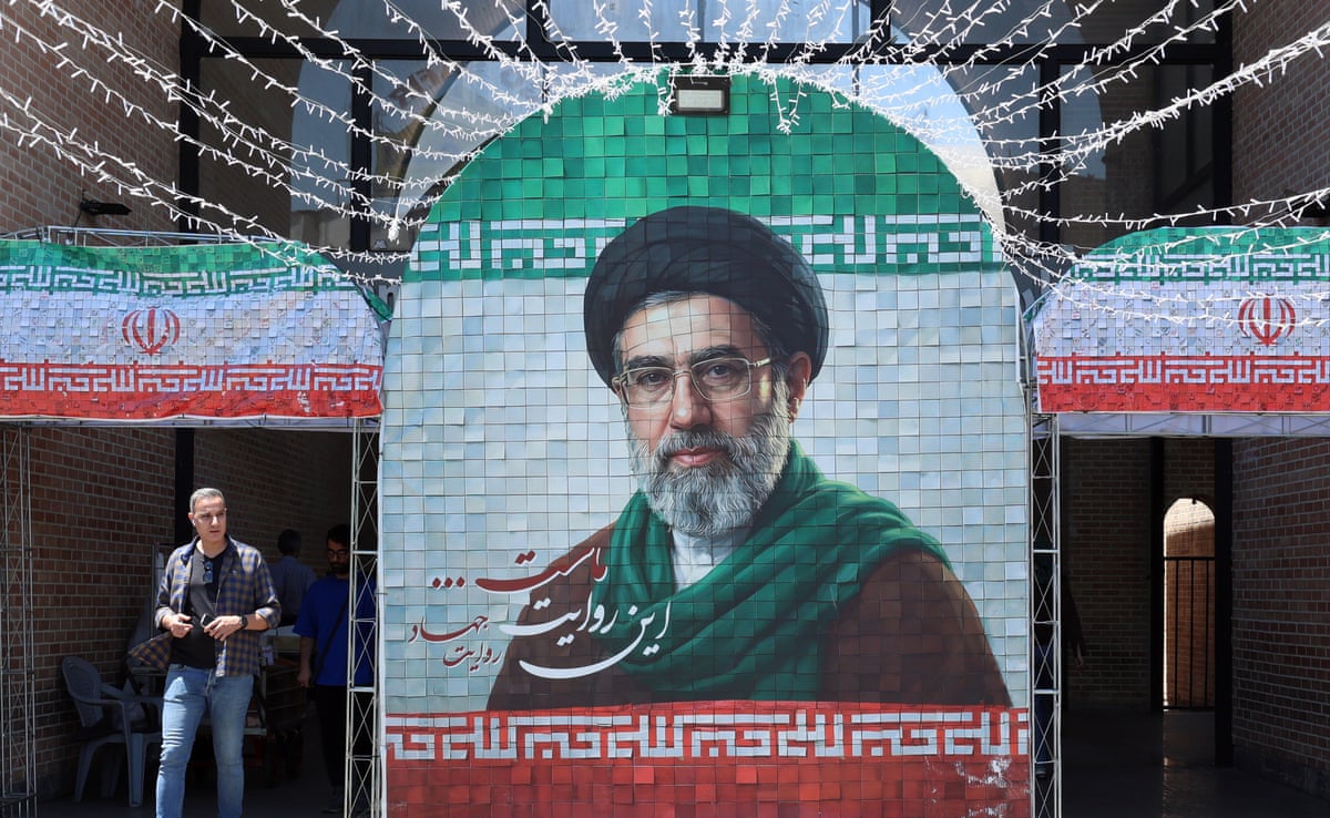 An Iranian man walk past a picture of supreme leader Mojtaba Khamenei in a street in Tehran.