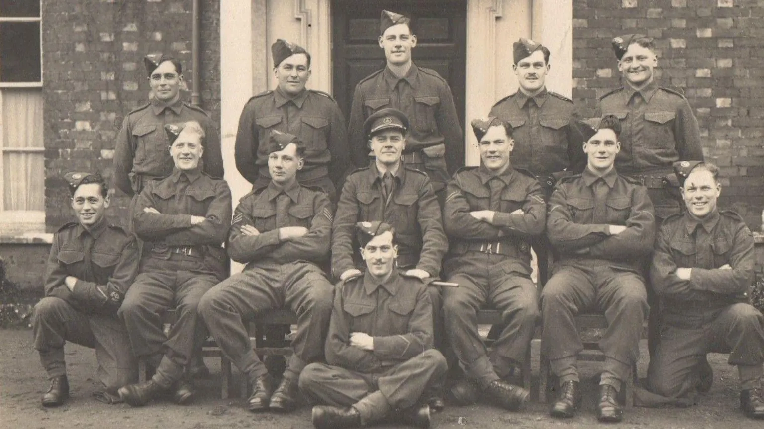 Joanna Burri-Weaver Black and White image of the members of the Dorset Regiment Scout Section of Auxiliary Units outside Chestnut House in Blandford. Maj Weaver is middle row and centre.